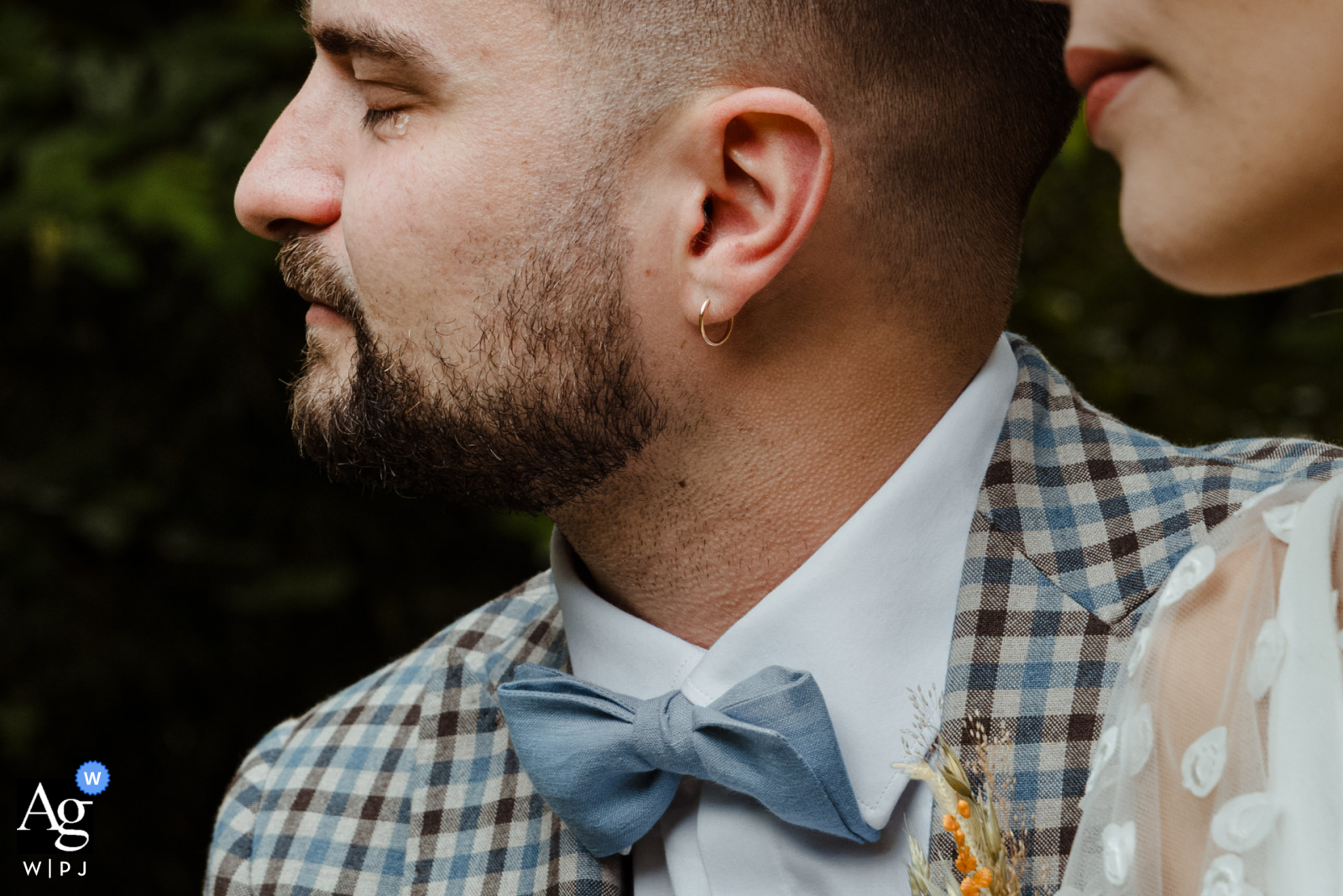 At the reception venue, Domaine du Moulin Neuf in France, a detailed photo captures a poignant moment as the groom closes his eyes, a tear falling while shivers run down his neck during a heartfelt speech at the secular ceremony.