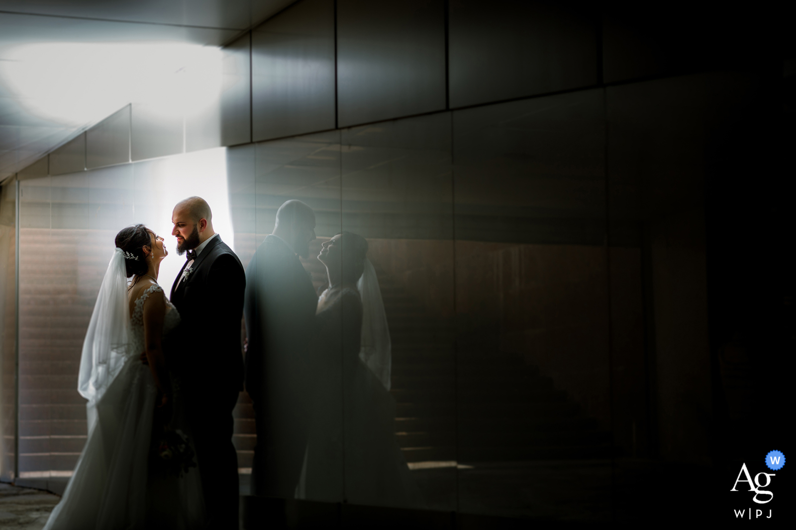 In Sofia's Central Universal Store (TSUM), the couple faces each other in a hallway, with their reflections prominently featured, emphasizing the depth and connection in this creative portrait.