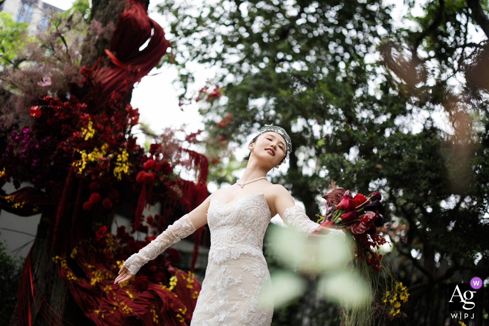 At Guinean Teahouse, the bride stands surrounded by vibrant spring scenery, fully immersed in the natural beauty of the setting where the couple holds their wedding.