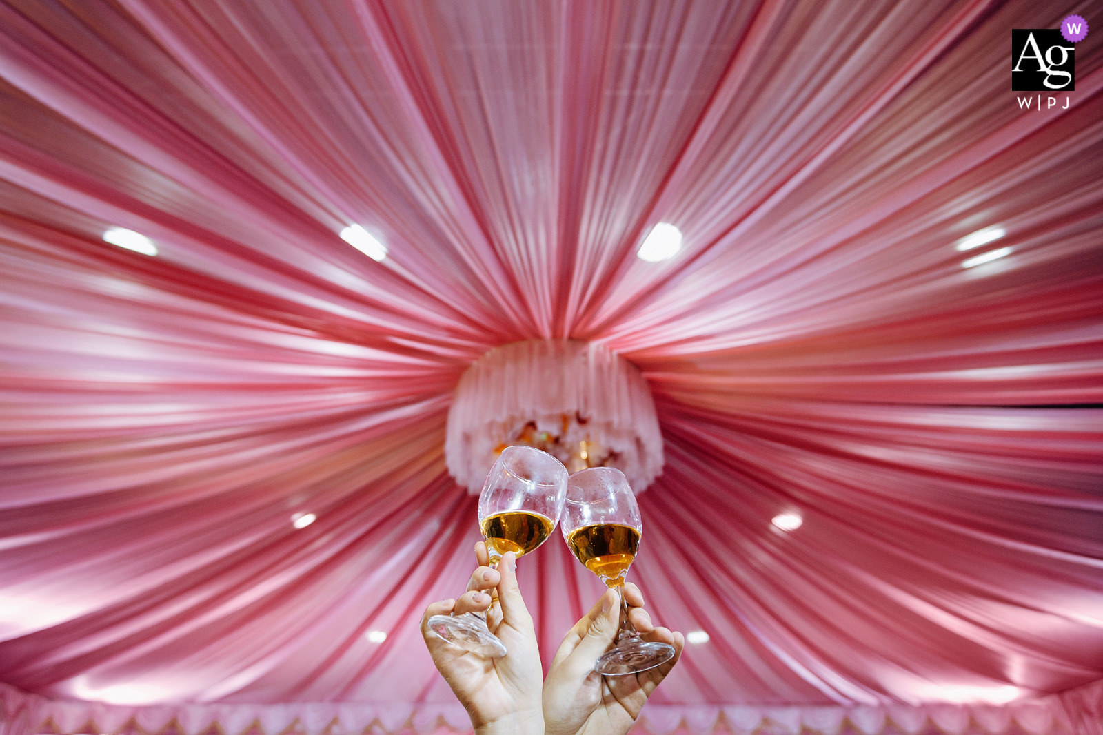 Newlyweds Raise Glasses In Artistic Toast Portrait At Nanping Fujian China Dinner Party The celebratory dinner party for guests in Nanping, Fujian, is documented with an artistic detail shot of the happy newlyweds raising their shimmering glassware in a beautiful toast to their marriage.