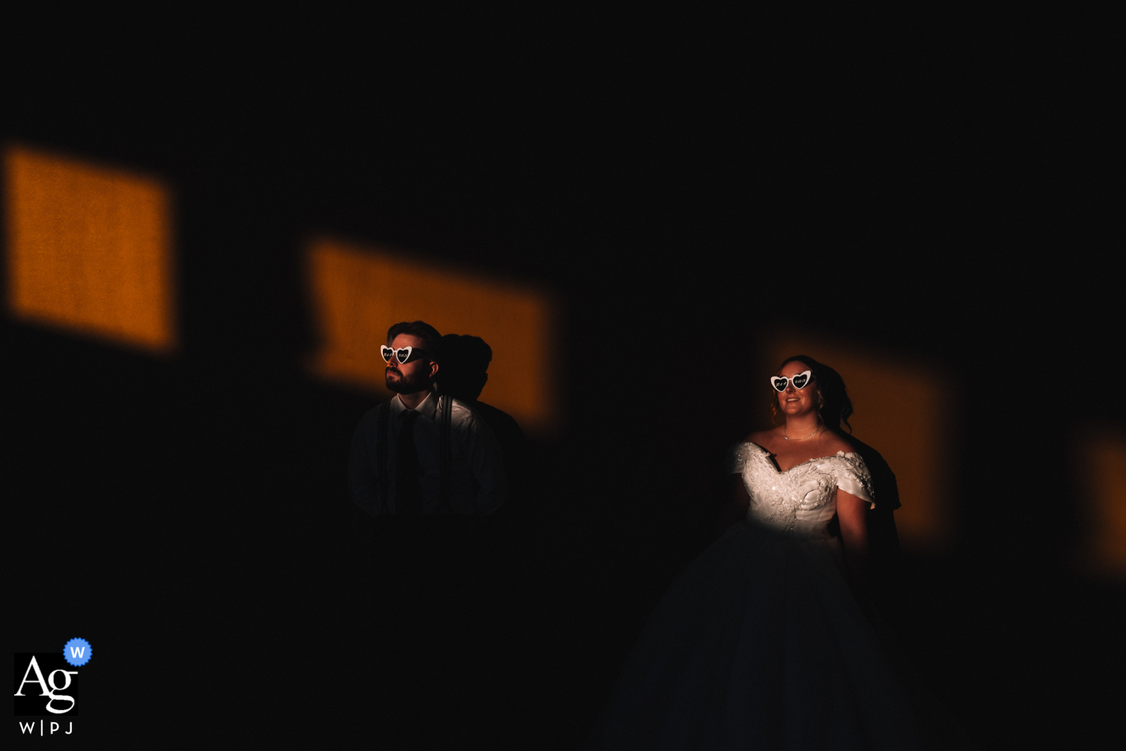Bold Dramatic Wedding Portrait With Striking Light At Domaine Des Plaines France Domaine des Plaines, France — The bride and groom are captured together in a bold, dramatic wedding portrait, both illuminated within a striking frame of light that creates strong contrast.