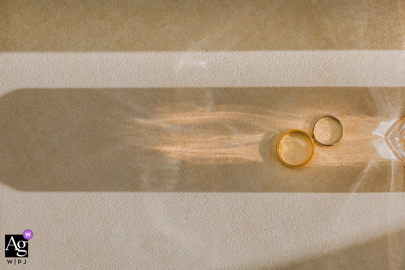 Istanbul, Turkey: The wedding bands rest artfully on a sun-drenched surface, creating a sparkling detail shot on the couple's wedding day.