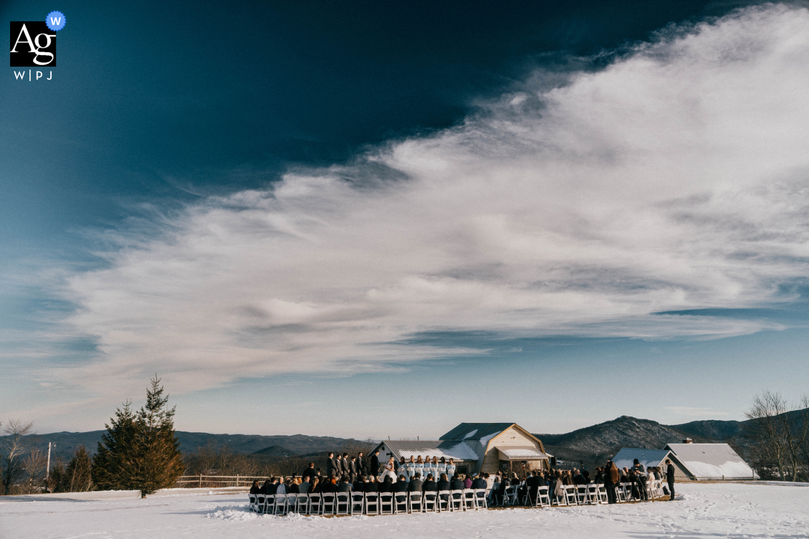   At Overlook Barn in North Carolina, a winter wonderland sets the scene for a mountain wedding ceremony, snowy landscapes framing the exchange of vows.