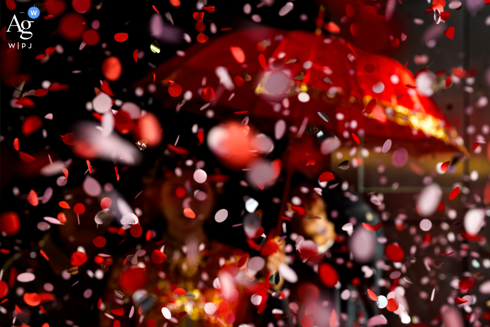   As the bride departs her home in Zhanjiang, Guangdong, flower petals are tossed in the air, creating a detail-filled scene as she steps toward the next chapter of her day.