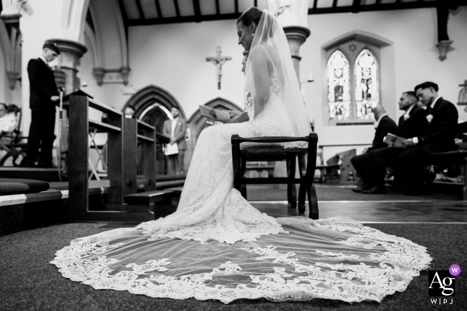  A wedding dress elegantly displayed within the stunning interior of Saint Mary’s on the Hill Catholic Church in Wednesbury, UK, highlighting the intricate details and atmosphere of the day.