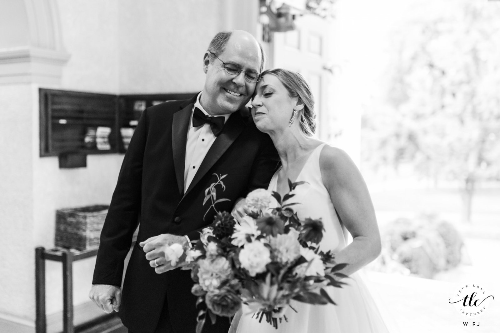 A heartfelt display of emotion is captured in this St Pauls Church, Charlottesville wedding day moment from a Virginia  documentary wedding photographer showing Bride and Dad sharing a hug as they are about to walk down the aisle 