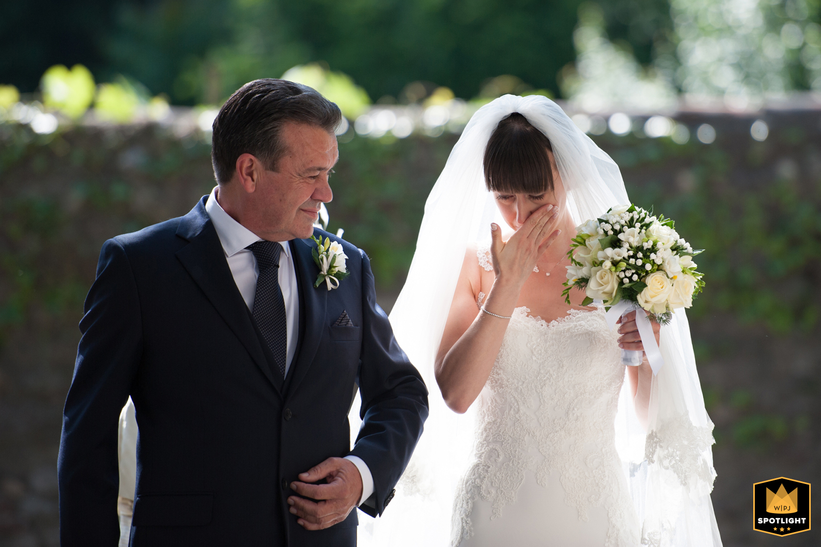 A lovely bride and her proud father enter the church on a sunny day at Villa Durazzo, in the beautiful town of Santa Margherita Ligure, Italy.