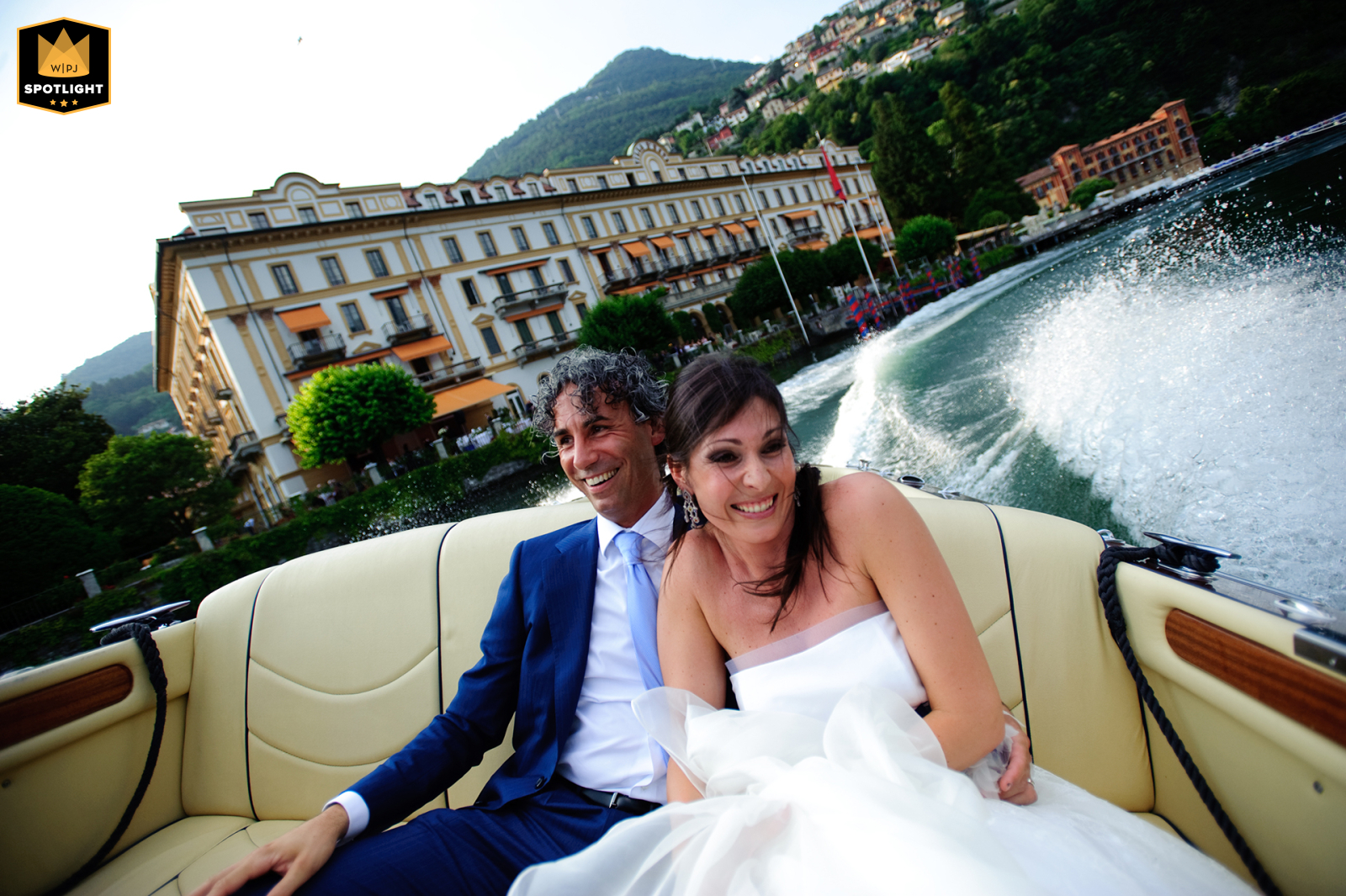 Thrilling Riva Ride on Como Lake: Bride's Wide-eyed Laughter Adds Adventure Near Villa d'Este On the shimmering waters of Como Lake near Villa d'Este, Italy, the bride clings tightly, wide-eyed and laughing, as the Riva motorboat speeds up, adding an unexpected thrill to the day’s adventure.