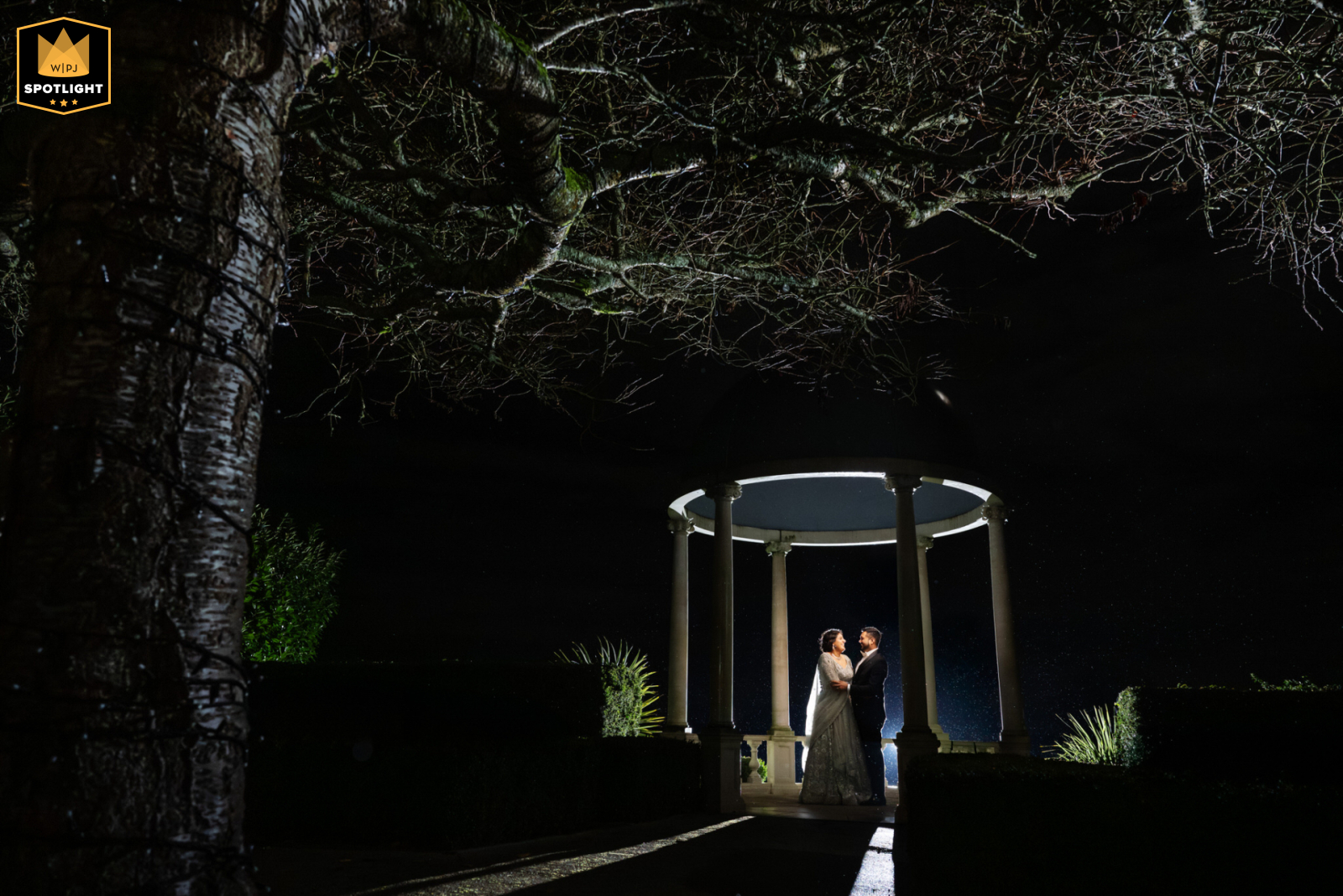 Nighttime Couple Portrait Outdoors at Froyle Park A nighttime portrait at Froyle Park shows a couple standing together. The photo is taken outdoors, after dark, at the venue.