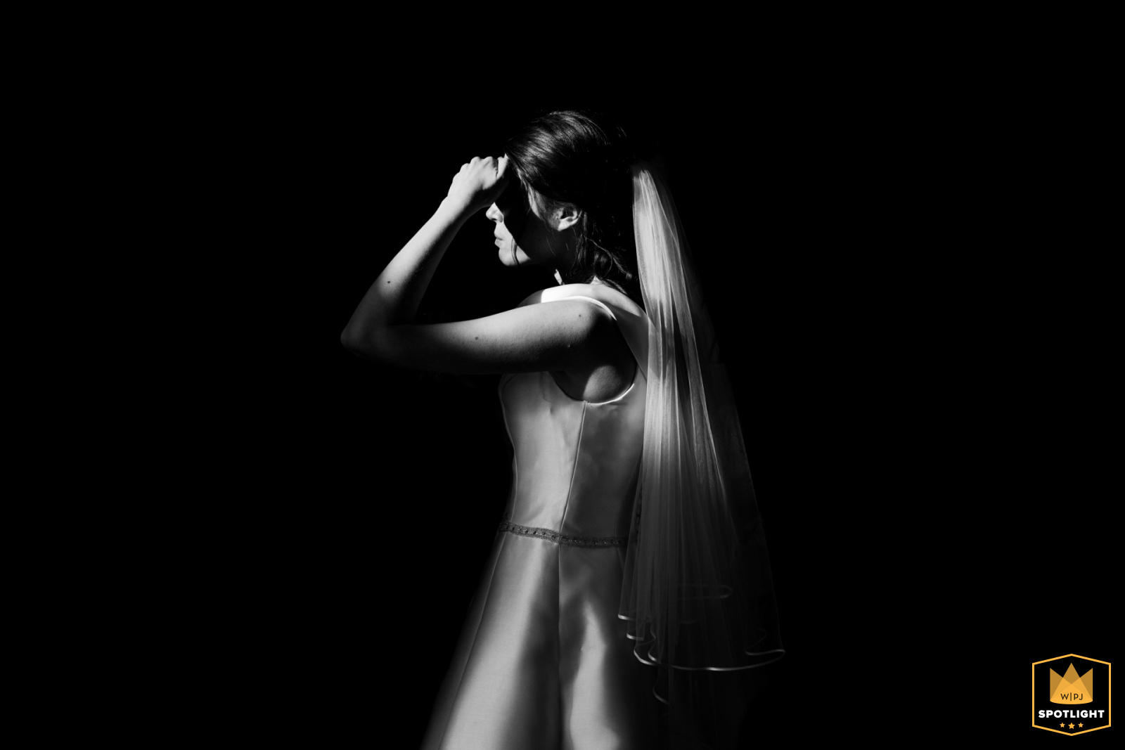 In Poitiers, Vienne, at the reception venue, beautiful lighting highlights the bride during the indoor cocktail hour.