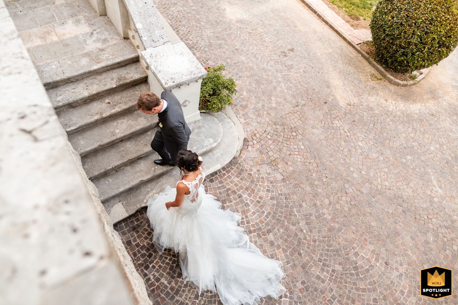 Capriva del Friuli: Bride and Groom Ascend Stairs From a top-down view at the venue in Capriva del Friuli, Gorizia, Italy, the bride and groom ascend the stairs together.