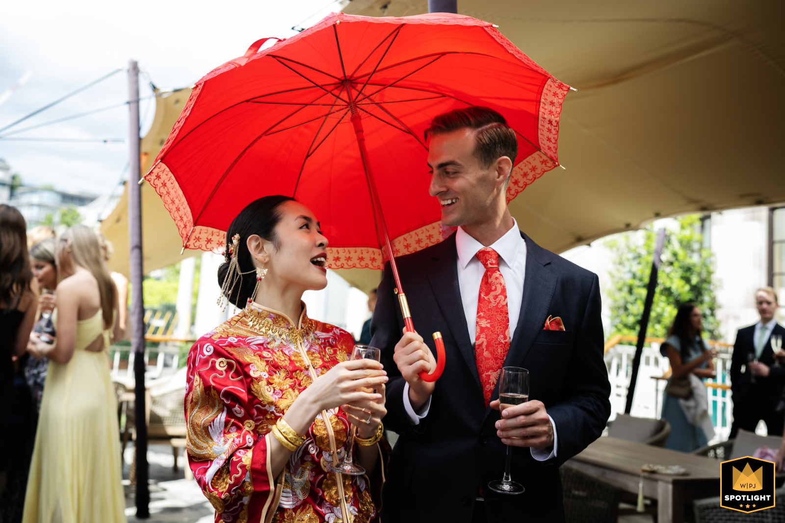 At No.4 Hamilton Place, a couple at their Chinese wedding, with the groom holding a red parasol over the bride.