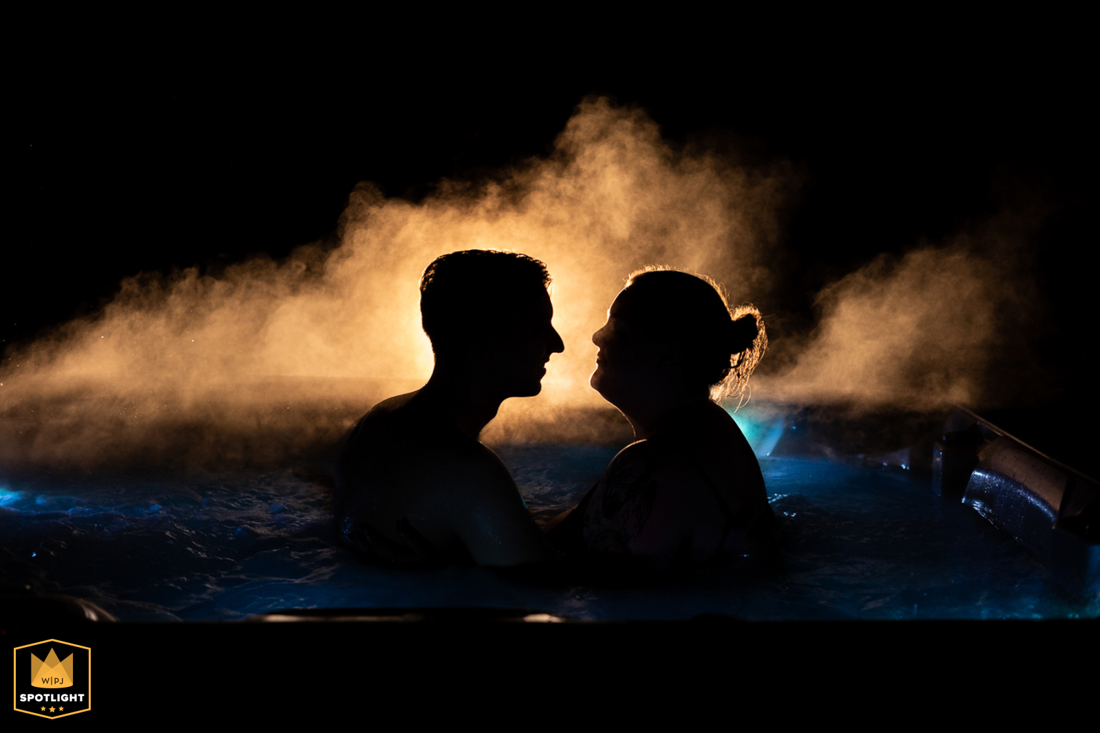 After their wedding ceremony, a couple shares a romantic night in a hot tub at Yosemite National Park, California. The intimate scene captures their relaxation.