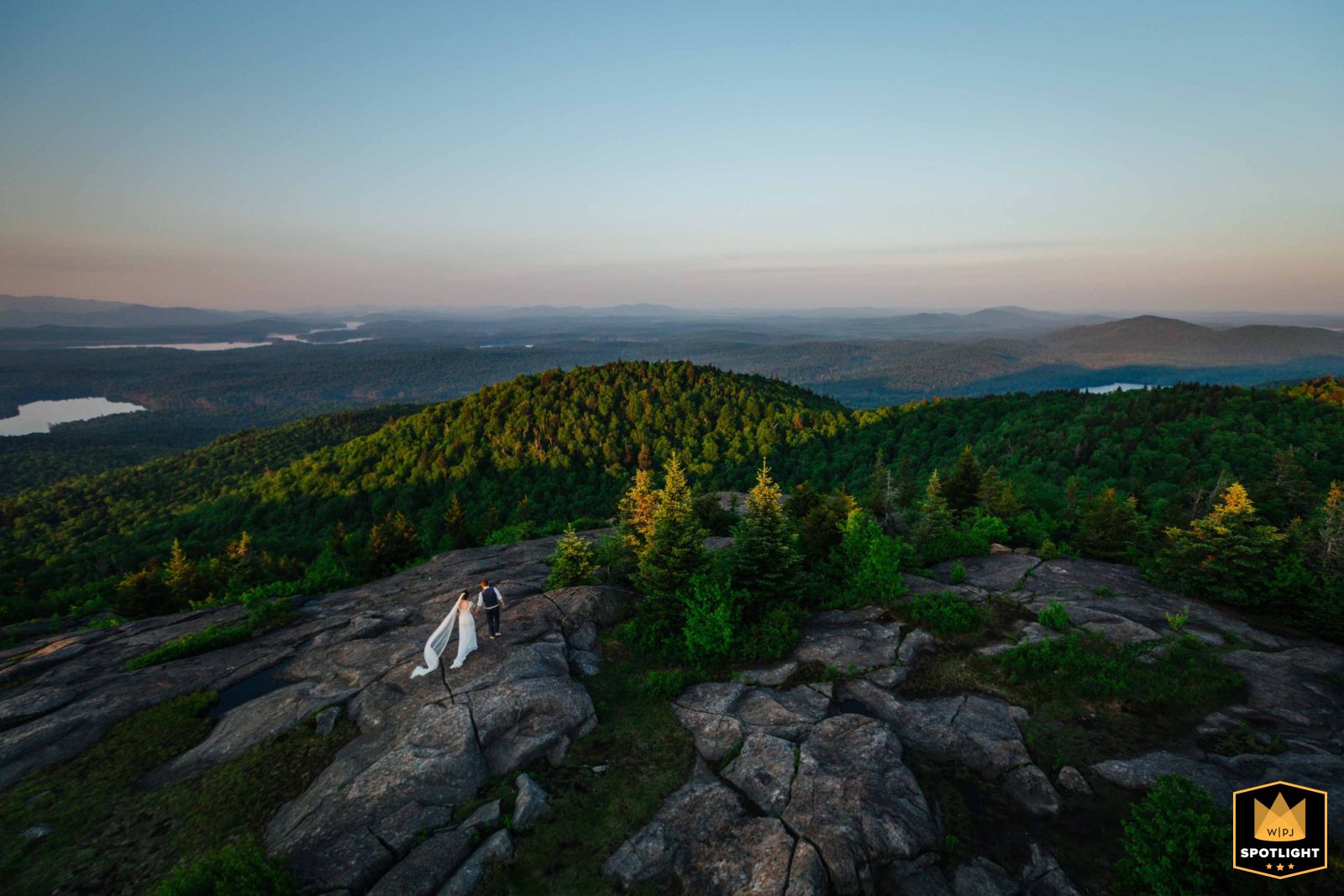 From the top of the fire tower in the Adirondacks, the couple is seen hiking around the mountain’s summit. This sweeping scene-setting image beautifully captures their adventurous spirit and the breathtaking natural landscape surrounding them.