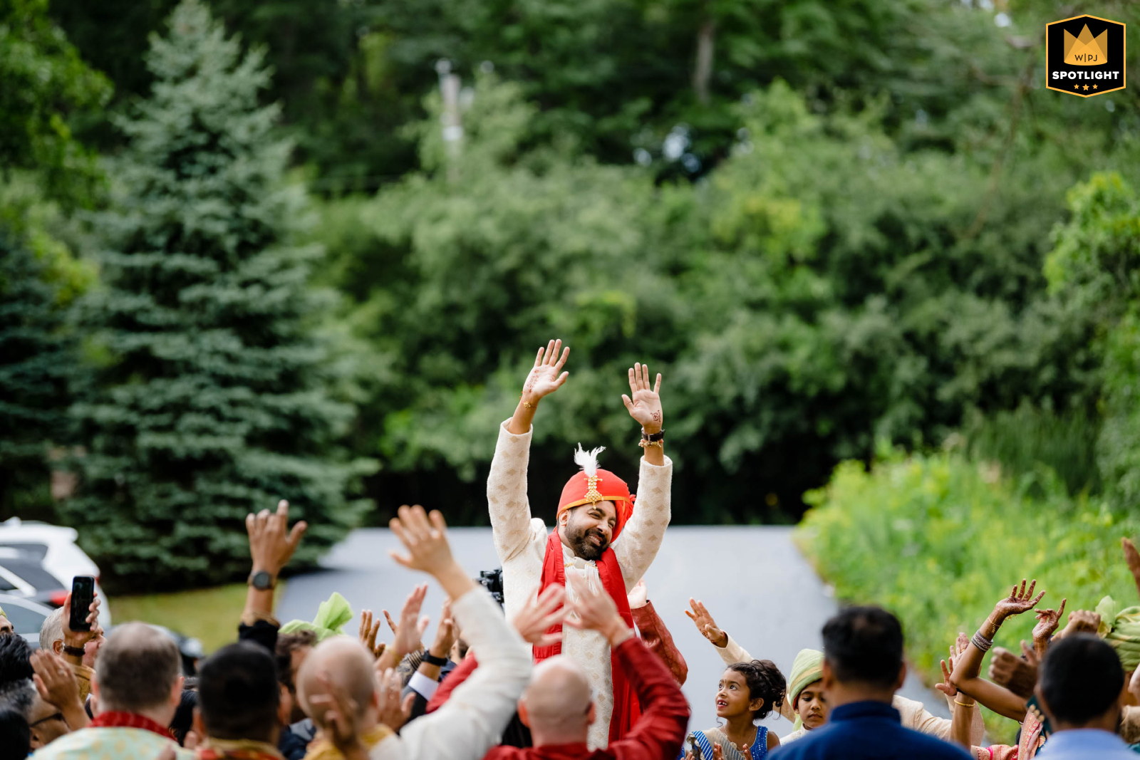 In Barrington Hills, IL, the groom arrives at the wedding ceremony during the vibrant baraat procession. Surrounded by lively music, dancing, and celebration, his entrance marks a joyful and colorful start to the festivities.
