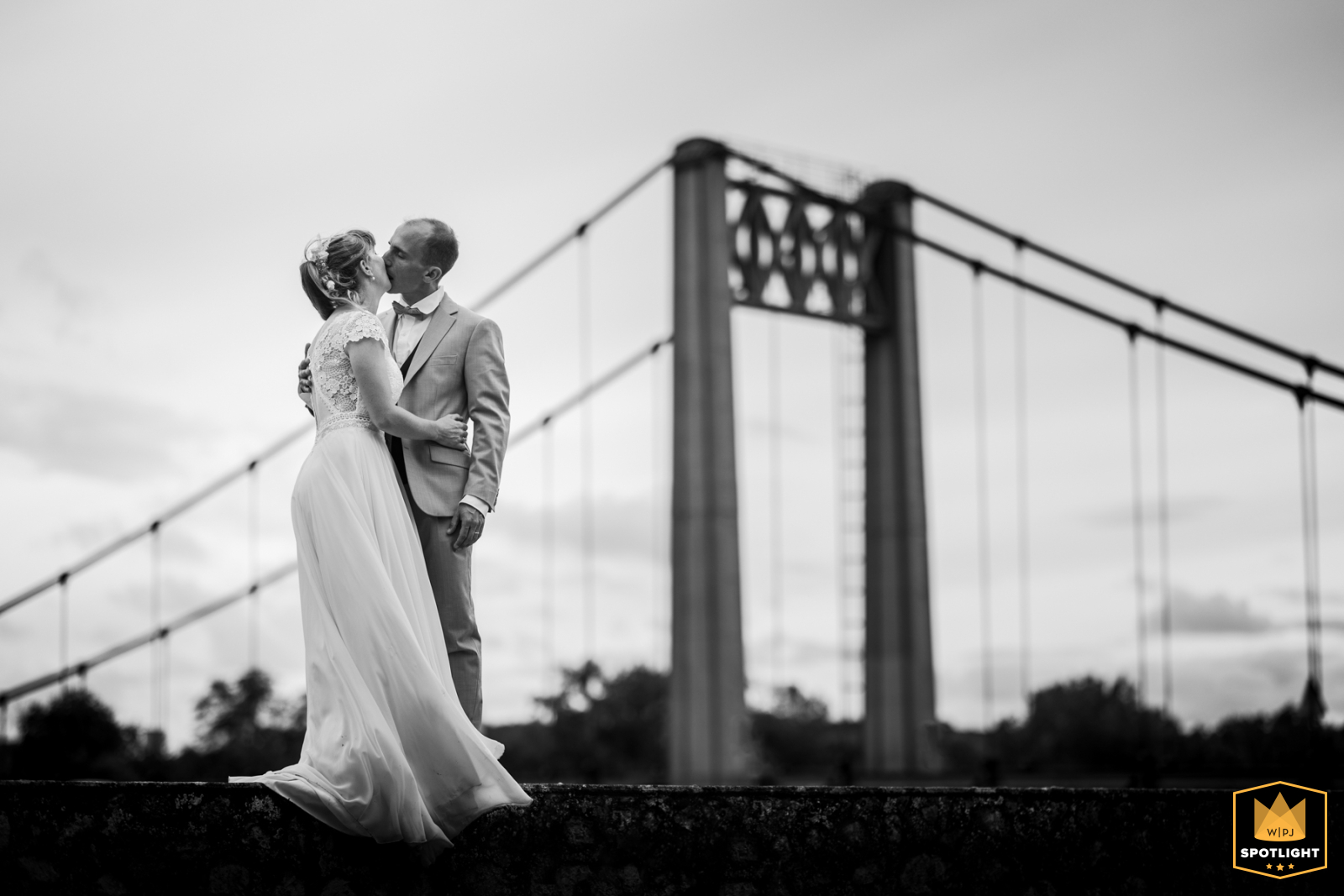 A couple poses next to a bridge, Les Rosiers sur Loire.
