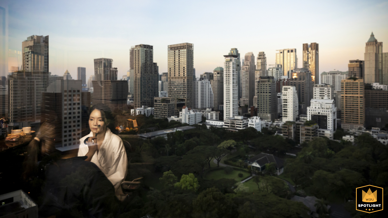 Bride Prepares With Makeup Surrounded By Skyline Views At Athenee Hotel In Bangkok, Thailand Getting ready at The Athenee Hotel in Bangkok, anticipation fills the air as the bride prepares with makeup for her wedding, surrounded by the hotel’s luxurious atmosphere and a skyline view.