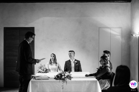 The bride and groom sat at a small table as the mayor perform the intimate civil ceremony for their special day