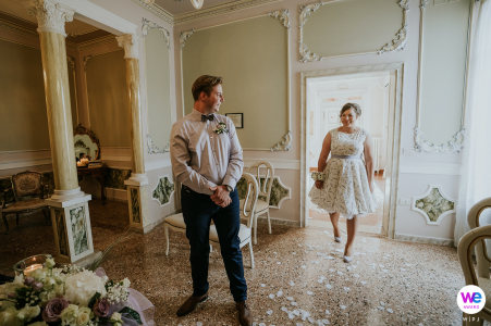 The groom was captivated as he looked over his shoulder at the stunning bride who had just arrived for their small elopement wedding; the perfect moment captured in a beautiful photo