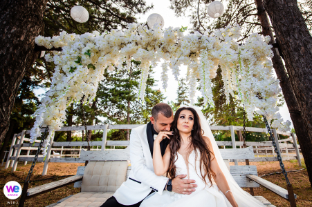 The bride and groom took a moment to relax before the start of the small wedding party; snuggling close in the cradle, they enjoyed the blissful newlywed moments together