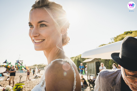 Beach Elopement Image of The bride arriving for her beachfront wedding Outdoor beach wedding photo as the bride basks in the sunlight