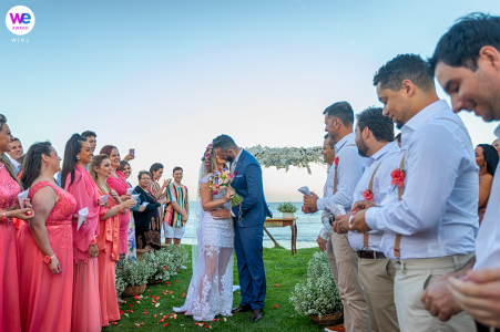 Beach Wedding Ceremony Picture | The bridal party created a wall of support for them during the ceremony