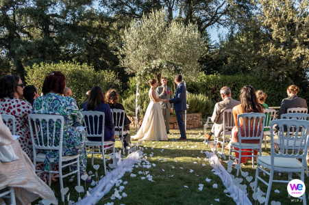 A small wedding in the middle of the gardens Outdoor wedding ceremony, with brides's older brother as the officiant