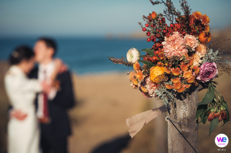 Bride And Groom Embrace On A Winter Beach In Brittany Newlyweds Marie and Edouard share a romantic embrace on the windy Quiberon beach during their intimate winter wedding in Brittany.