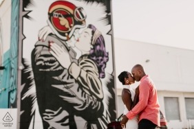 Engaged Couple kissing against giant mural in Wynwood, Miami, FL 