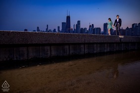 North Avenue Beach, Chicago Artful Engagement Picture for a couple walking in front of the skyline