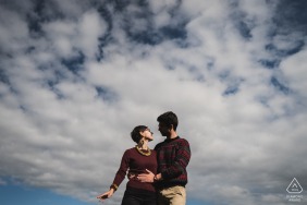 Golf du Morbihan, France portrait e-session using a low camera angle on The couple and shooting up into the clouds