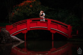 Toulouse bride and groom to be, modeling for a Jardin Japonais pre-wedding picture on a red bridge