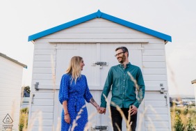 Shoreham Beach, West Sussex environmental couple pre wedding image session against an all white beach hut