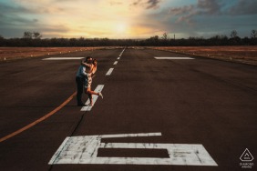 Outdoor Szeged, Hungary couple engagement photography portraits showing some Love on the runway