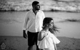 Maceió, Alagoas outside environmental couple prewedding photoshoot with a man and woman on the beach, and the wind blows her hair