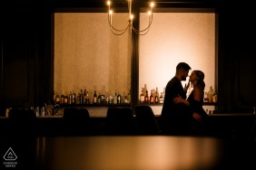 In the dimly lit ambiance of Nior Bar, a couple is captured in profile, standing close.