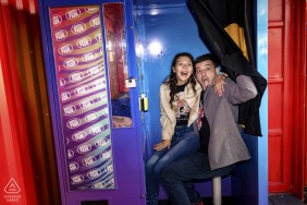 Caught mid-laugh in a burst of vibrant color, the couple turns a spontaneous interaction into pure, unforgettable fun during their energetic and joyful engagement portrait session at Budapest Park in Hungary.