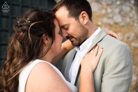 This romantic engagement portrait features a posing in a Provençal village in La Garde Adhémar, Drôme Provençale, France, amidst the region's historic stone architecture.