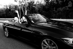 An excited couple waves a joyful goodbye at the end of their beautiful engagement portrait session held at the scenic and luxurious Viceroy Mexico Riviera Maya resort in Mexico.