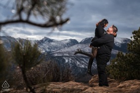 A joyous couple celebrates their love in the mountains of Colorado at Rocky Mountain National Park, Estes Park, surrounded by the breathtaking alpine scenery and clear, fresh mountain air.