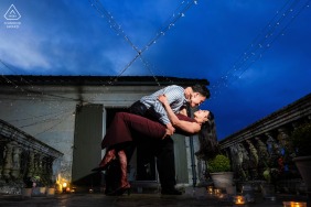 He lifts her gently as they hold each other beneath twinkling lights at Château des Sénéchaux in Bourdeilles, Dordogne, sharing a tender and romantic engagement portrait in rural France.