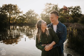 A joyful engagement photo session takes place under the warm autumn sun at Parc de Lacroix-Laval in Marcy-l'étoile, Rhône, featuring a couple surrounded by the vibrant and seasonal fall colors.