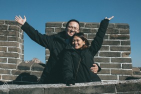 Celebrating their devotion at the Mutianyu Great Wall in Beijing, China, this engaged couple shares a romantic embrace that symbolizes a love destined to last for ten thousand years.