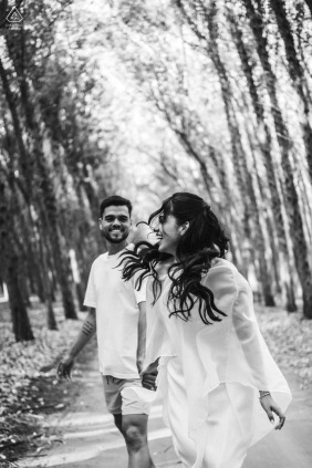 This joyful engagement portrait showcases a spontaneous and lighthearted interaction between the couple as they explore the scenic outdoor setting of Mar de Eucaliptos in Maceio, Alagoas, Brazil.