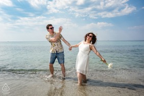 The couple shares a playful connection during their pre-wedding photo session in the coastal town of Çeşme, Izmir, Turkiye, overlooking the beautiful and clear Aegean Sea.