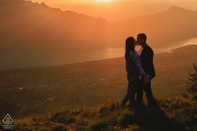 A romantic silhouette of love stands high above the world in Aix les Bains, Savoie, France, wrapped in stunning alpine sunset hues during a breathtaking and scenic engagement session.
