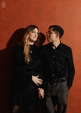 This striking hard light engagement portrait features a couple at the Julia Ideson Library in Houston, Texas, utilizing the dramatic shadows and historic architecture for a sophisticated and bold look.