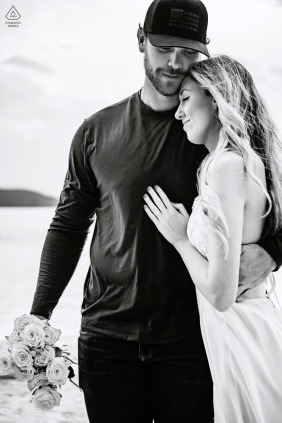 The couple shares a quiet embrace by the water in South Lake Tahoe, California, where their love feels calm and steady against the serene backdrop of the vast mountain lake.