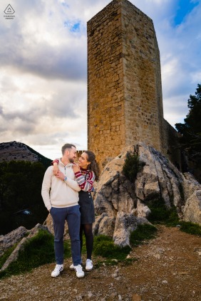 The couple enjoys an intimate and romantic engagement session at the historic Castillo de Santa Catalina in Jaén, Spain, surrounded by the grand stone architecture of the ancient fortress.