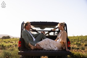 In Seguret, Provence, France, the couple sits together in the back of their truck, the scene evoking a cinematic romance as they savor a private, movie-like moment amidst winding village roads.